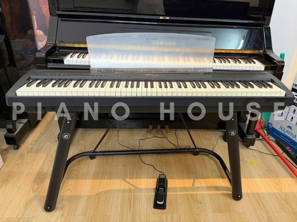 Đàn piano điện YAMAHA P-95 màu đen đặt trên giá đỡ, góc nghiêng trước